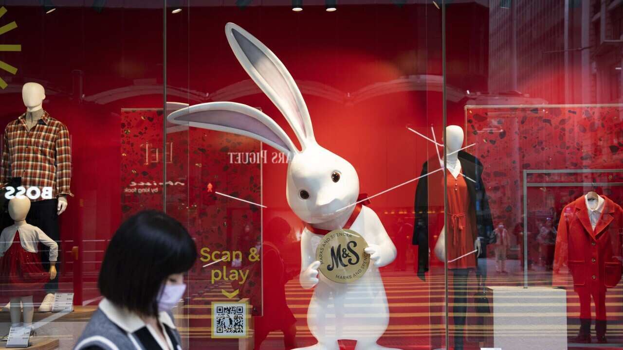 A woman passes a rabbit in central Hong Kong.jpg