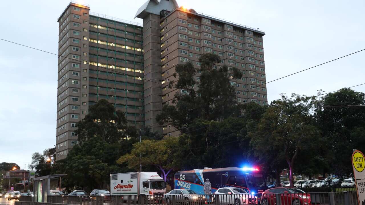 Police are seen enforcing a lockdown at public housing towers in Racecourse road in Flemington, Melbourne.