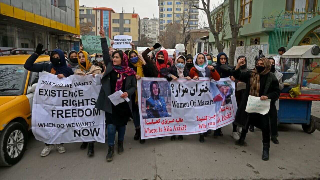 Afghan women march as they chant slogans and hold banners during a women's rights protest in Kabul on 16 January, 2022.