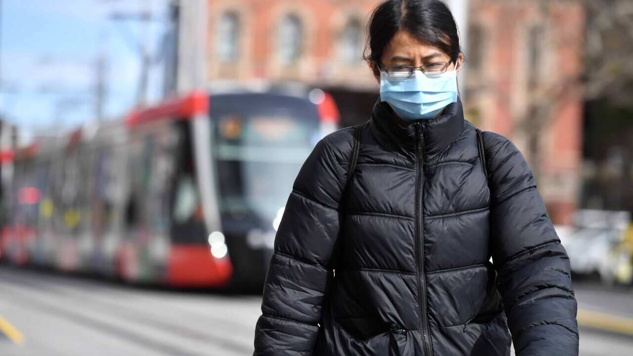 A pedestrian wearing a face mask in Sydney