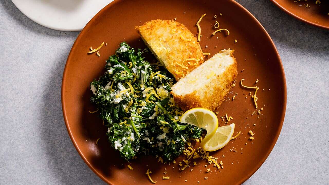 Herring cakes with kale salad and cured egg yolk