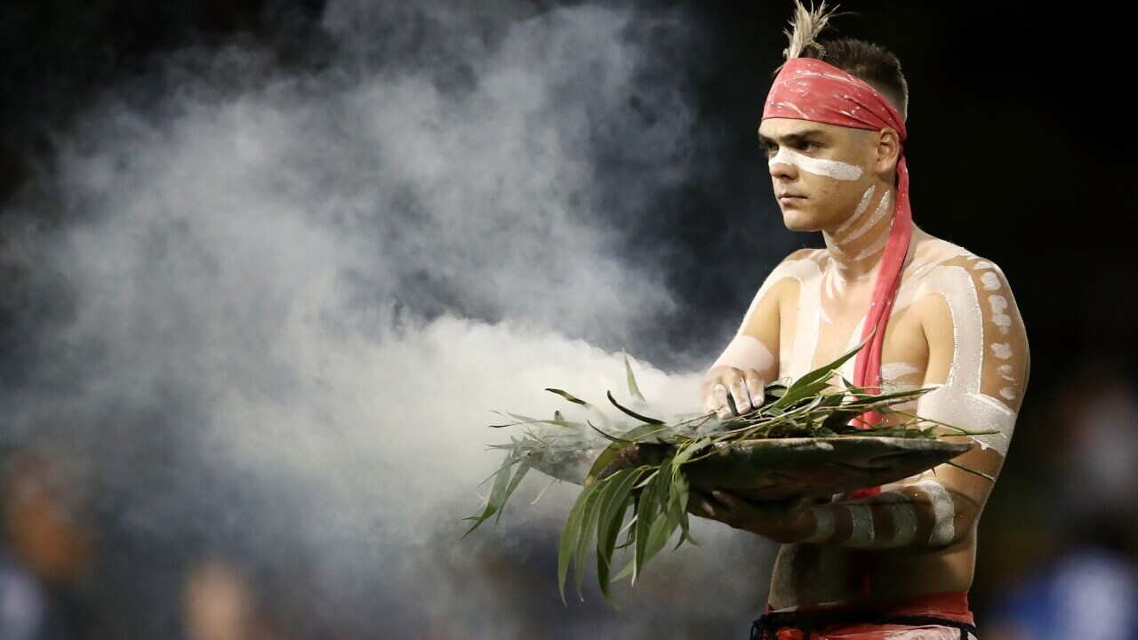 An Indigenous performer participates in a smoking ceremony Cameron Spencer/Getty Images