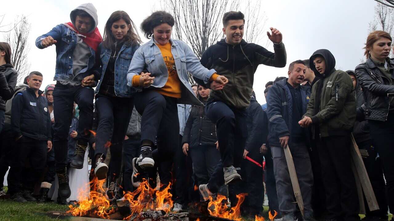 Teenagers jump over a bonfire during the Newroz celebrations in Istanbul, Turkey.