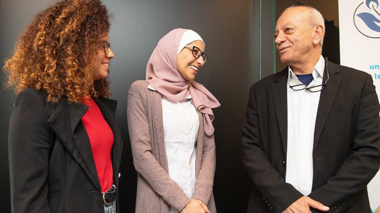 Aiia Maasarwe's sister Noor and father Saeed with fellowship recipient Dr Khadra Hasan Salami (centre).