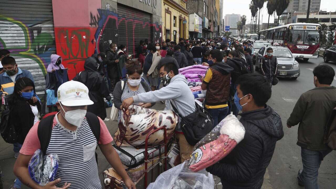 Streets vendors and shoppers wearing masks