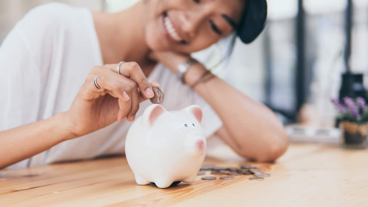 Piggy Bank for saving money.Hand holding money for savings and financial management.