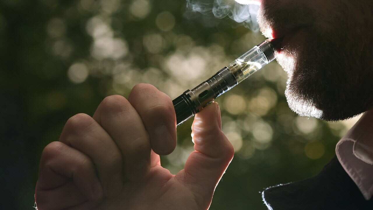 A man smoking an electronic cigarette (vape). 