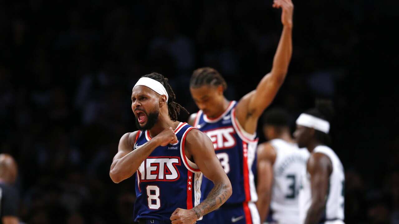 Brooklyn Nets guard Patty Mills (8) reacts after making a 3-point shot against the Milwaukee Bucks during the first half of an NBA basketball game Thursday, March 31, 2022, in New York. (AP Photo/Noah K. Murray)