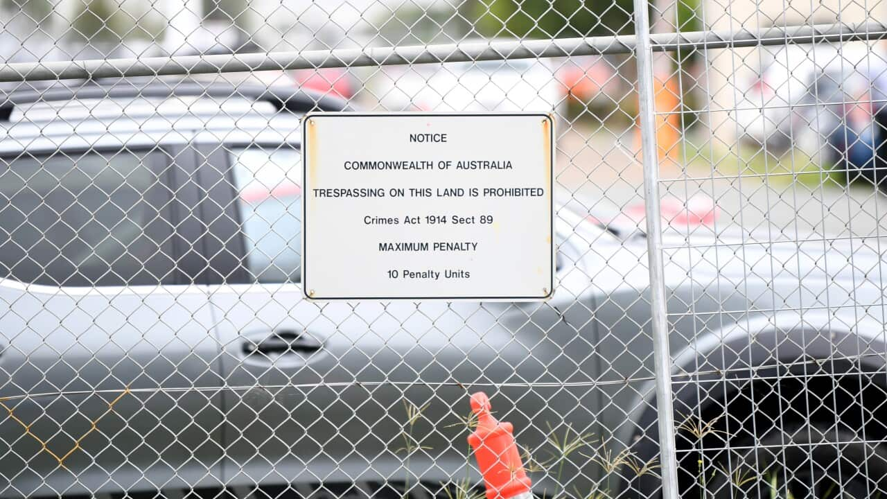 A warning sign on the fence of the Brisbane Immigration Transit Accommodation, where a number of Medevac transferees are held. 