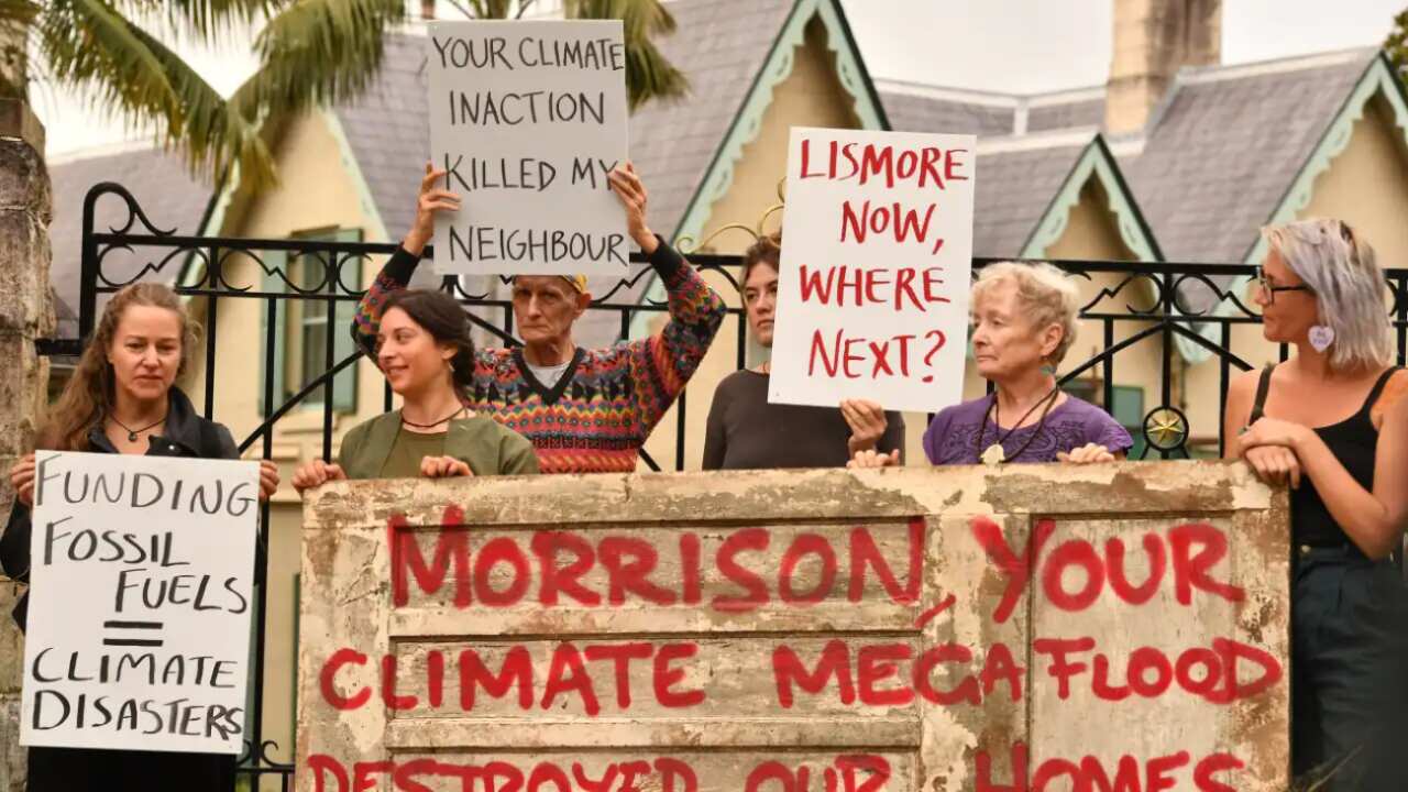 Flood-affected residents of Lismore dump household flood-damaged items outside Prime Minister Morrison's residence of Kirribilli House in Sydney on Monday.