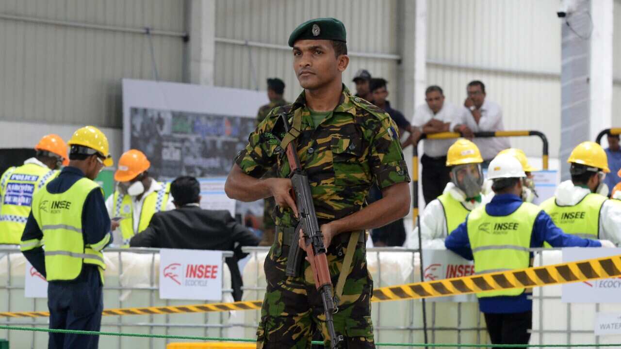 A Sri Lankan soldier stands guard next to seized cocaine