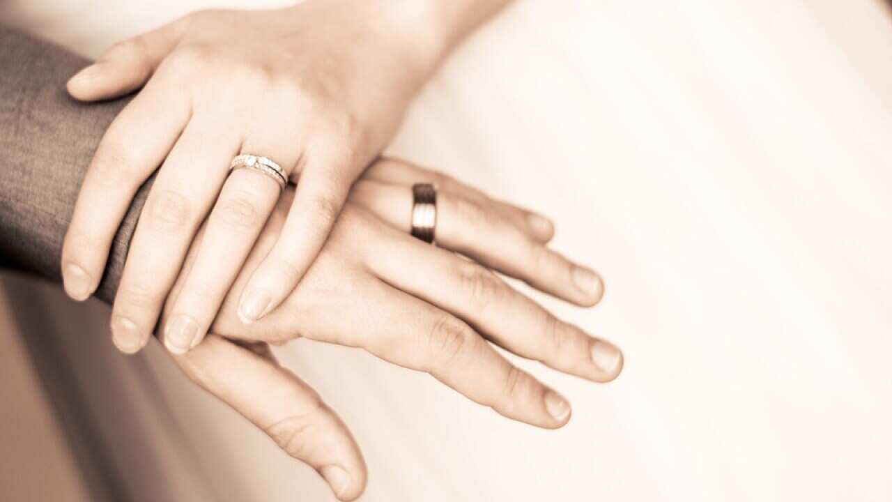 Image of a couple holding hands by Pixabay