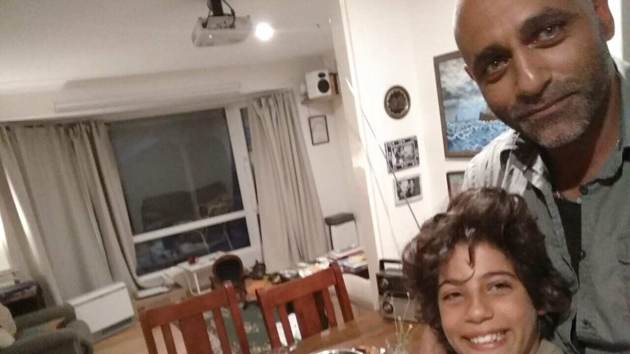 A father and son take a selfie before dinner