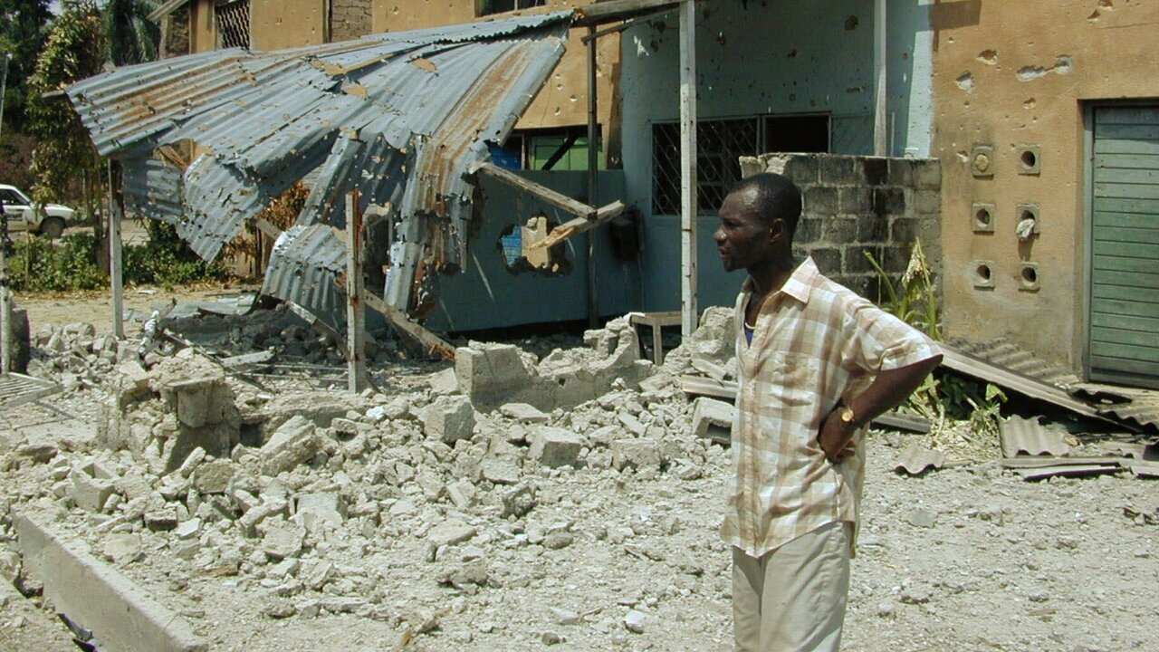 A Congolese man looks at the destruction of the Tshopo neighborhood of Kisangani, where Rwandan and Ugandan armies had battled for a week in 2000. 