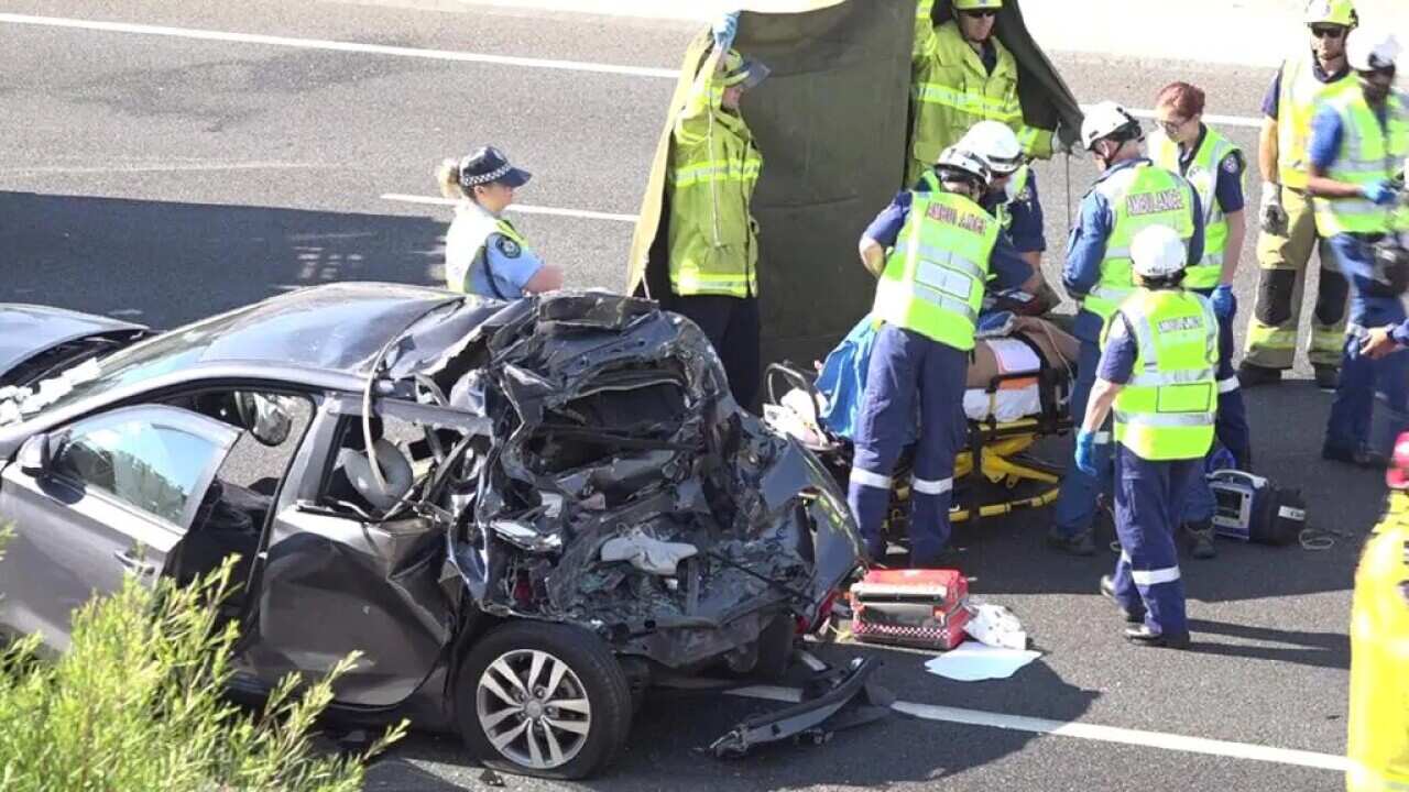 A child died and another in injured when 3 cars and a truck crashed on Sydney's M5