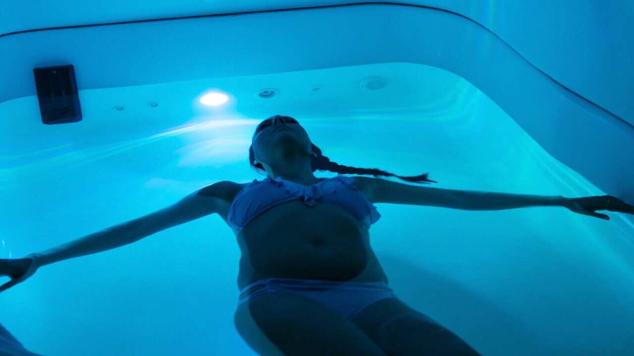 Young woman in sensory deprivation tank