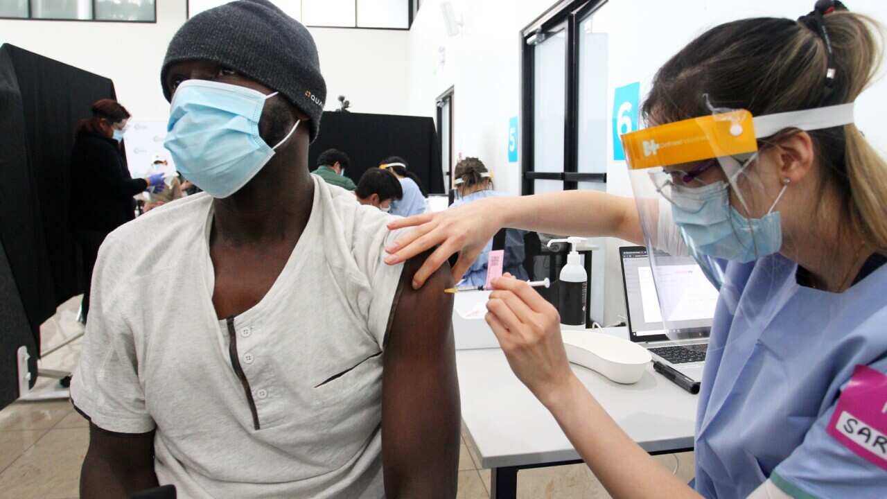 SYDNEY, AUSTRALIA - AUGUST 08: Registered Nurse Sarah administers a COVID-19 vaccine at a vaccine pop-up clinic at the Lebanese Muslim Association (LMA) in Lakemba on August 08, 2021 in Sydney, Australia. 