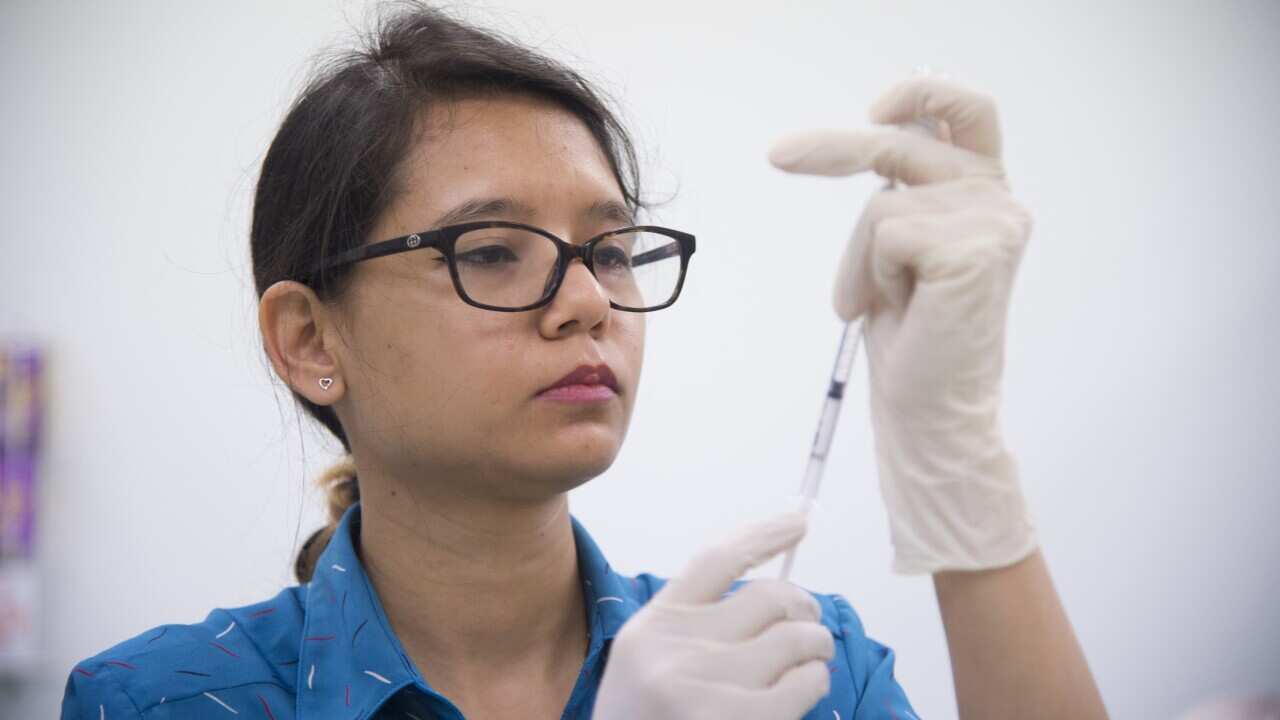 A nurse at a Darwin GP clinic prepares a dose of the AstraZeneca COVID-19 vaccine for a patient on day one of Phase 1b of the rollout on Monday, 22 March. 