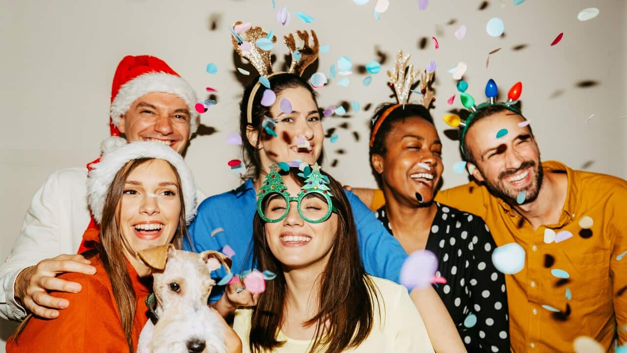 Friends posing for a photo at a Christmas party