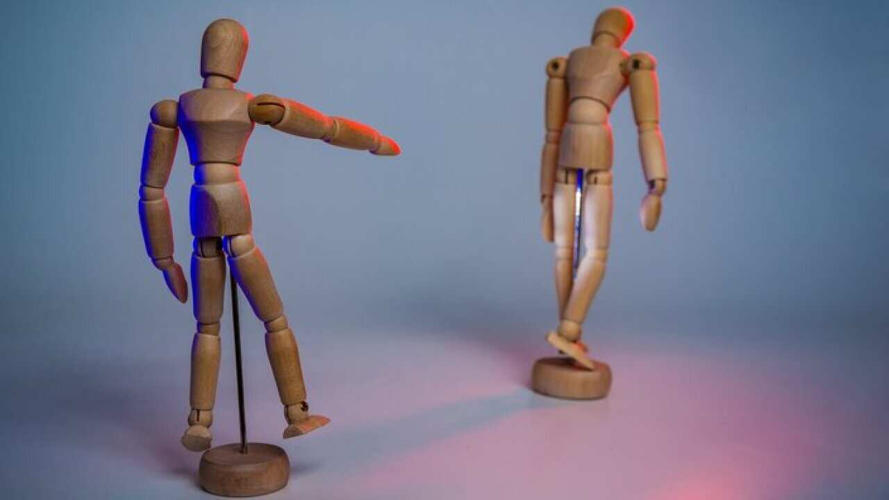 Wooden Figurines Against Gray Background