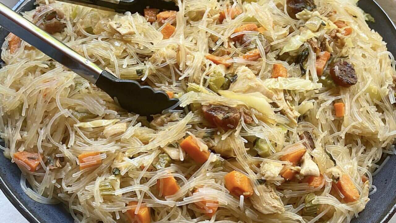 Filipino noodles pancit bihon is always served on a large plate