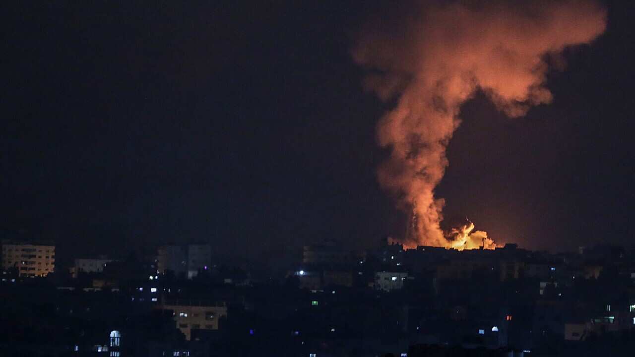 Smoke and flames rise after an Israeli airstrike in the northern Gaza strip, 14 May 2021. 