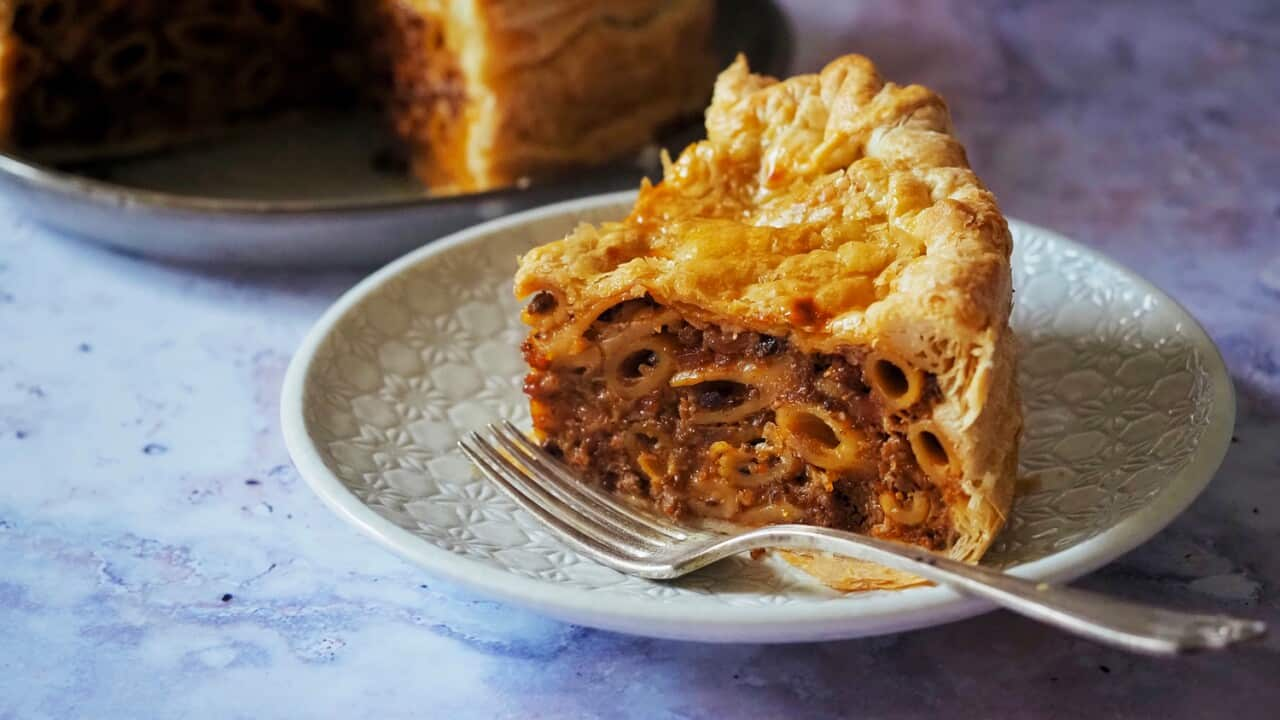 A slice of timpana on a white plate