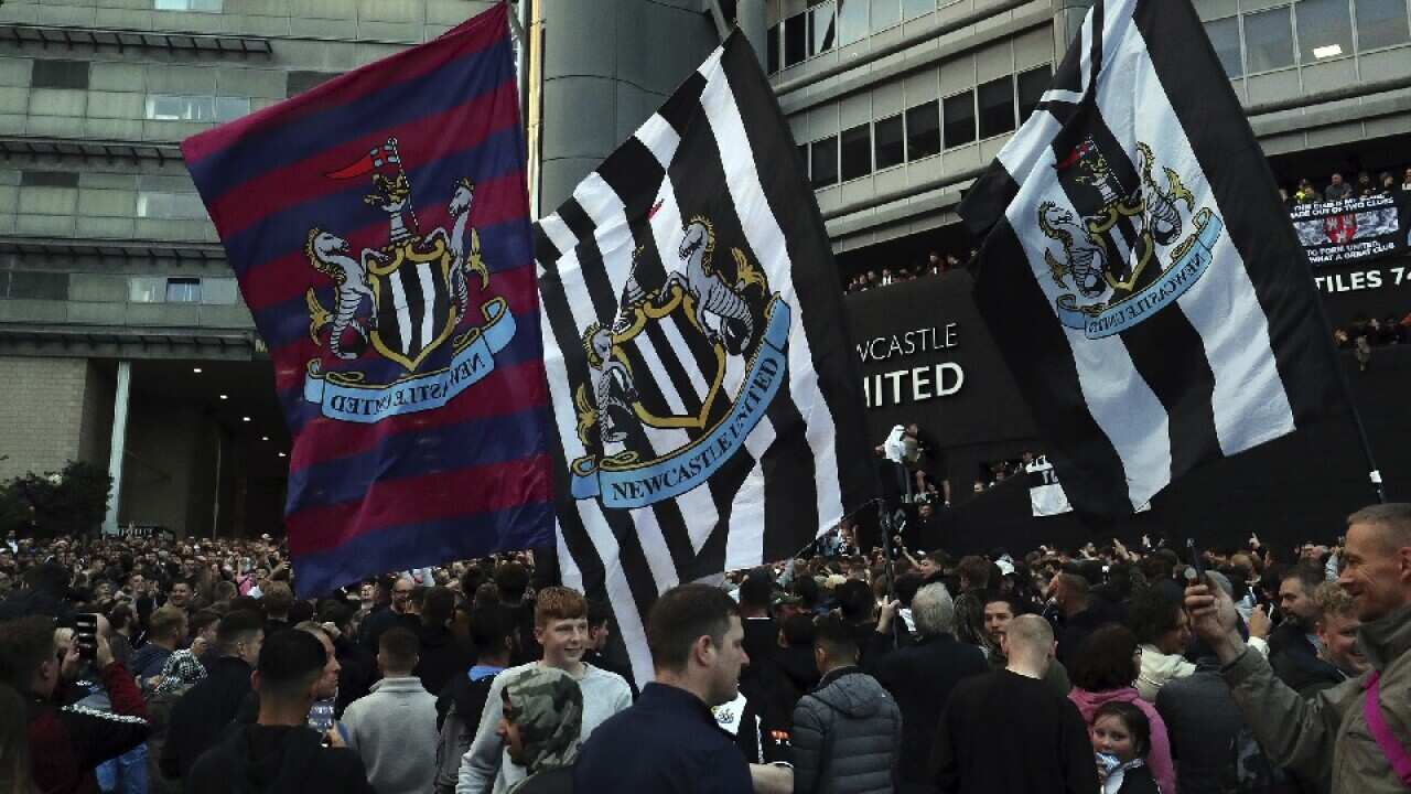 Newcastle United supporters celebrate outside St James' Park in Newcastle Upon Tyne, England on 7 October 2021. 