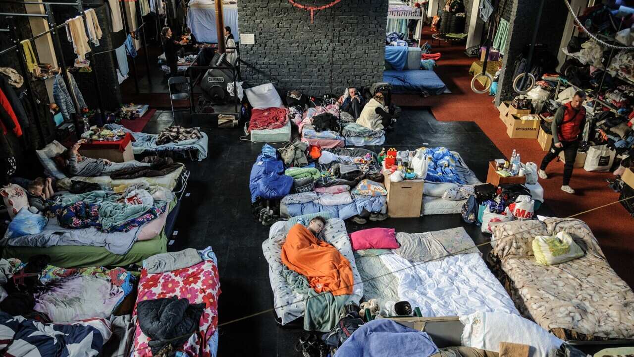 People seen at a gym converted for accommodation for refugees from the Russian military aggression in Ukraine. (Photo by Mykola Tys / SOPA Images/Sipa USA)