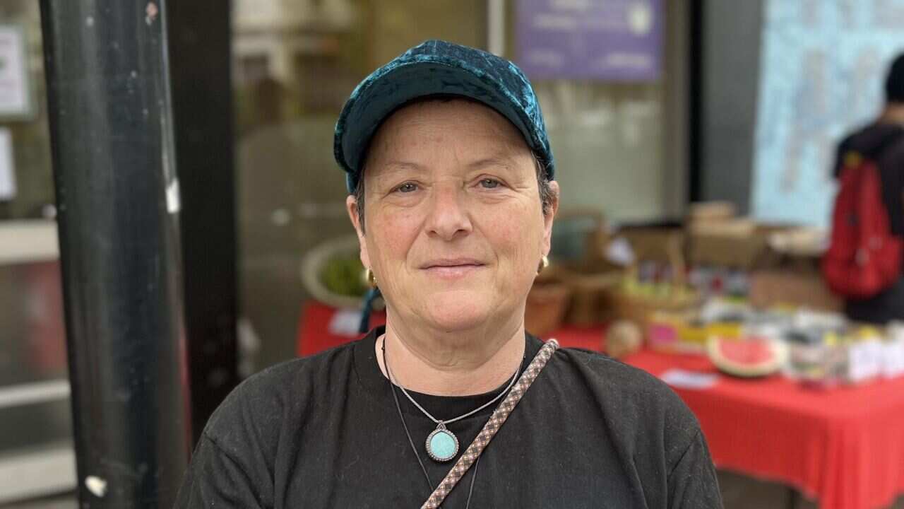 A woman in a blue cap and black T-shirt