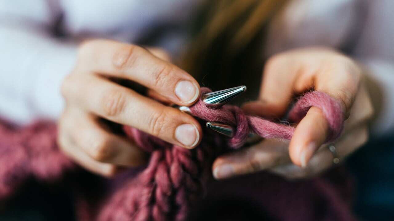 Woman knitting.