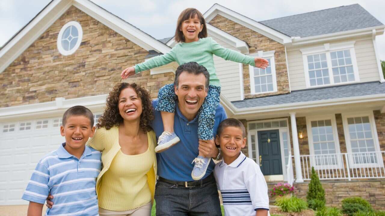 Hispanic family in front of house 