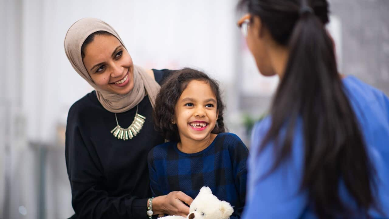 Little Girl at The Doctor with Her Mother stock photo