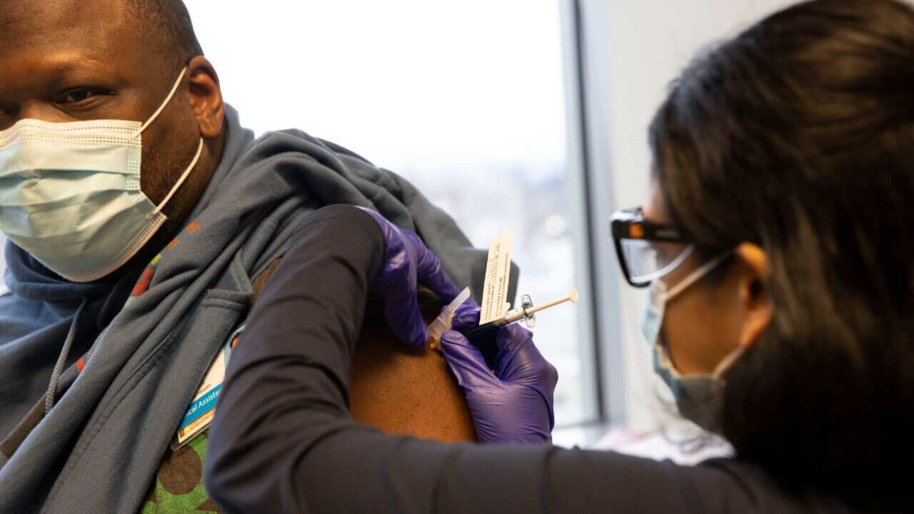 Dr Stephaun Wallace receives his second injection during the Novavax COVID-19 vaccine phase 3 clinical trial in Seattle, Washington, US.