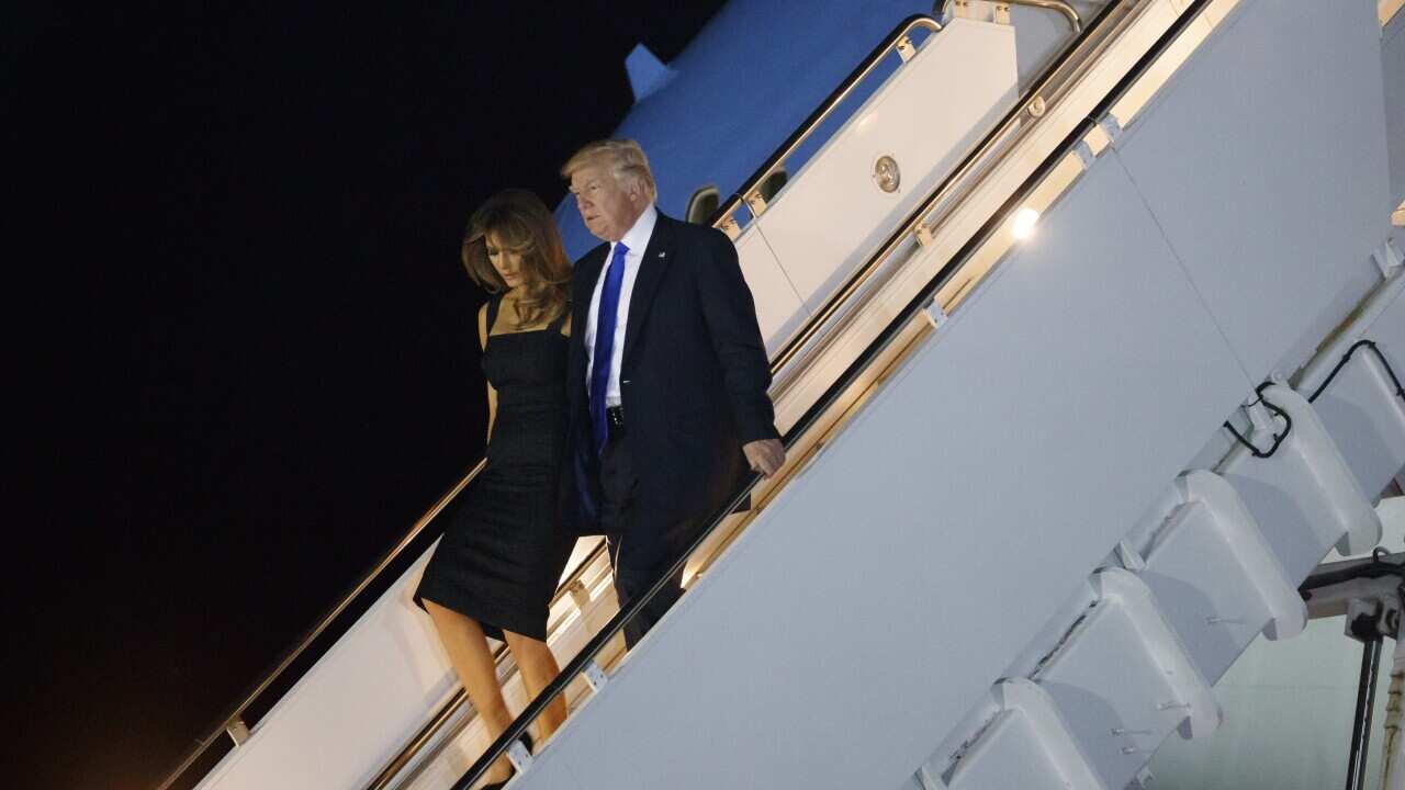 President Donald Trump and first lady Melania Trump disembark Air Force One.