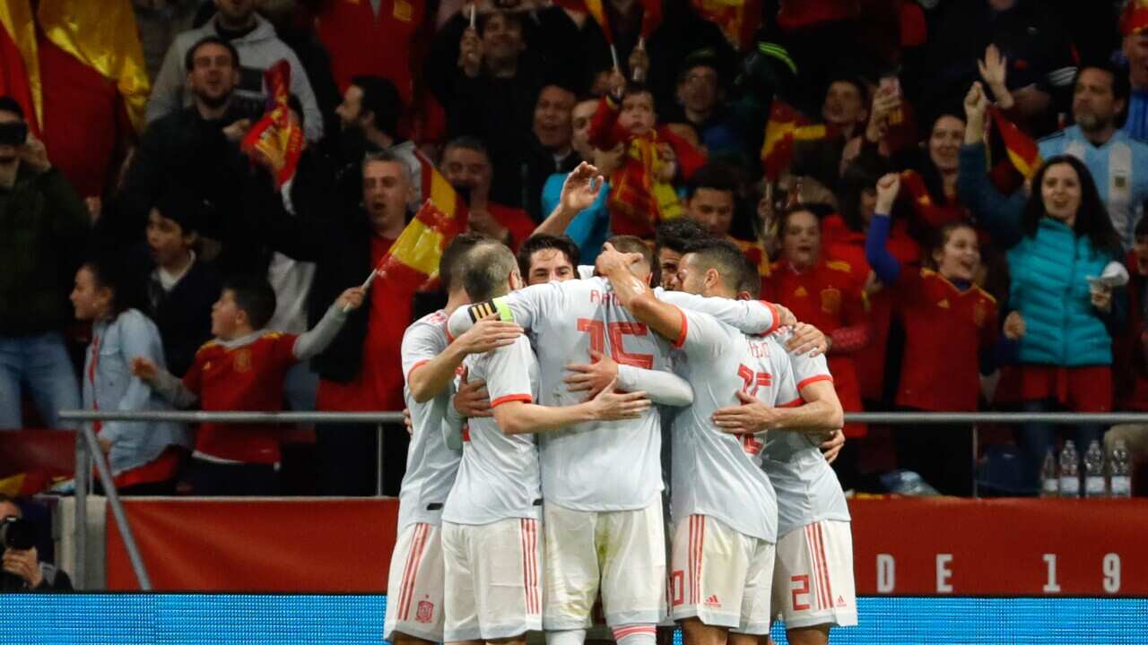 Spain embrace after scoring against Argentina