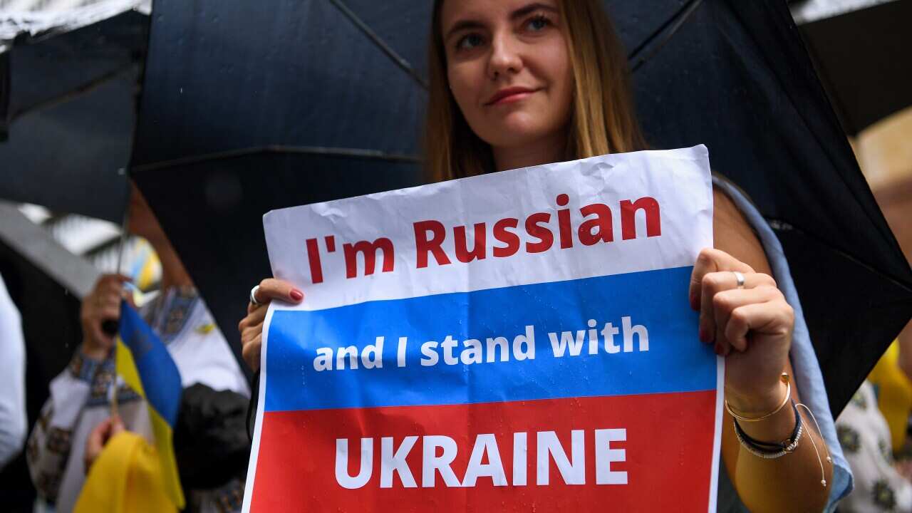 A Russian woman holds a sign during a rally in Sydney against the war in Ukraine.