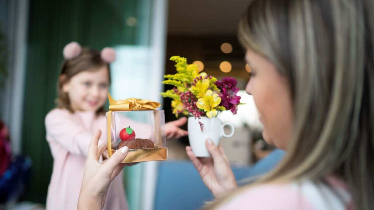 Girl giving gifts to her mother, mother's day celebration