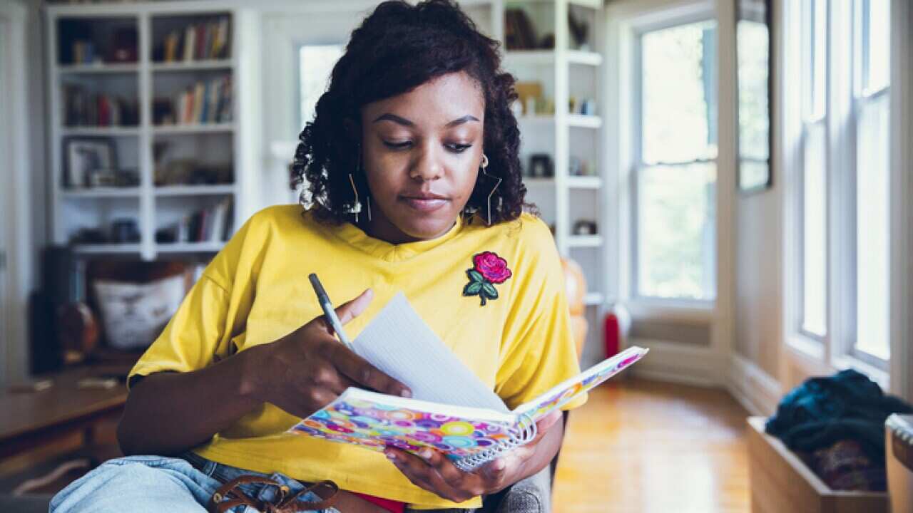 Women writing in journal