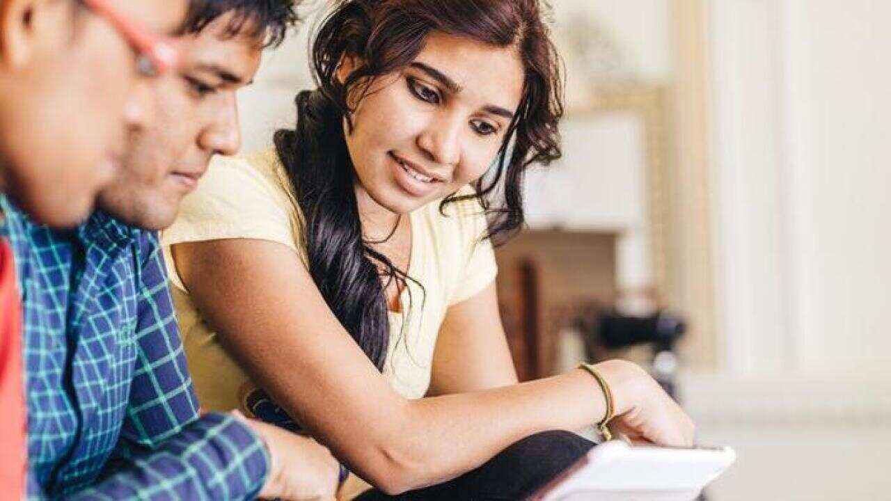 Young students using digital tablet