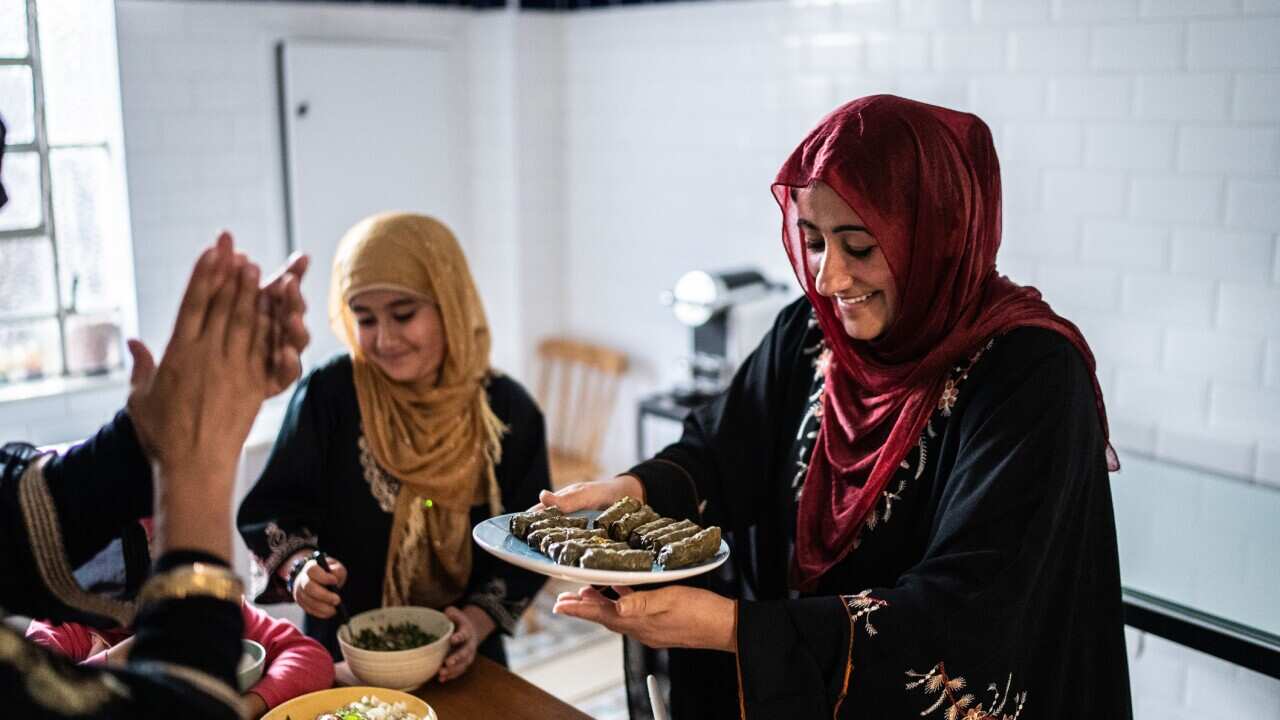 Muslim women preparing food at home.