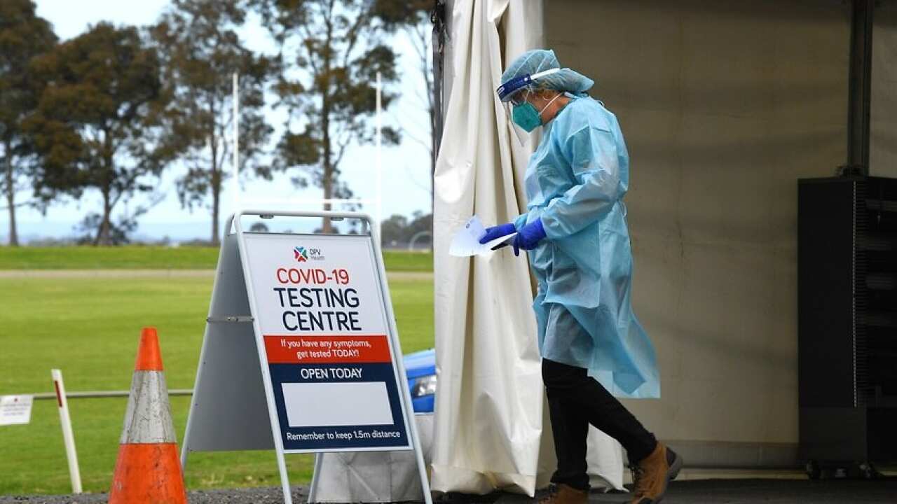 Healthcare workers work at a drive through pop up coronavirus testing facitlity in Melbourne.