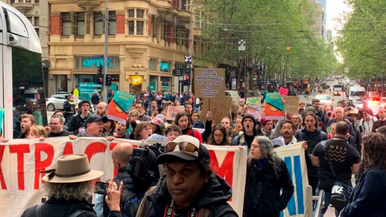 Extinction Rebellion protesters marching on Collins Street.