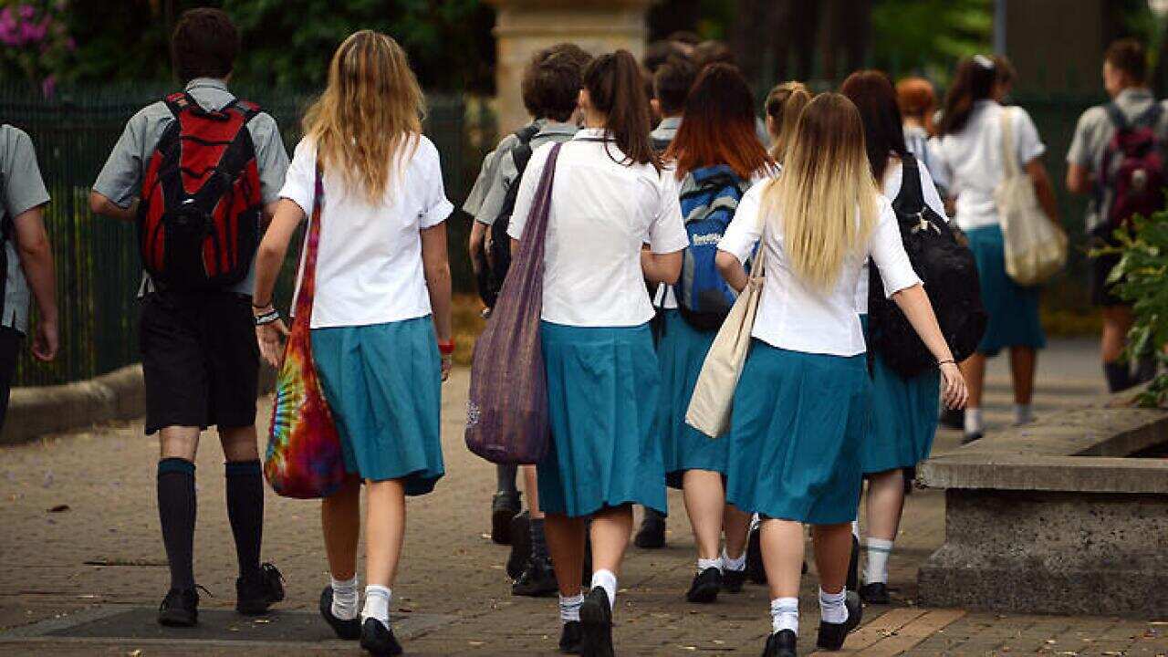 A group of high school students walk together during a school excursion in Brisbane, Friday, Nov. 1, 2013. (AAP Image/Dan Peled) NO ARCHIVING