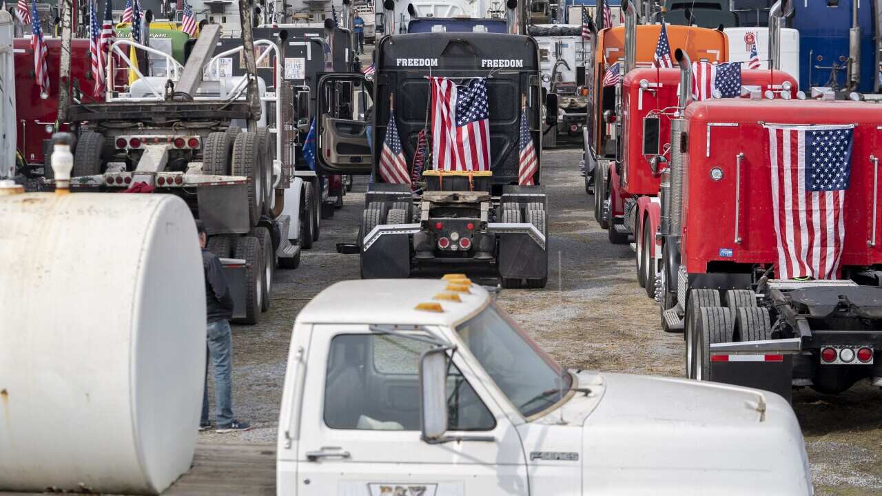 Trucks with American flags are seen.