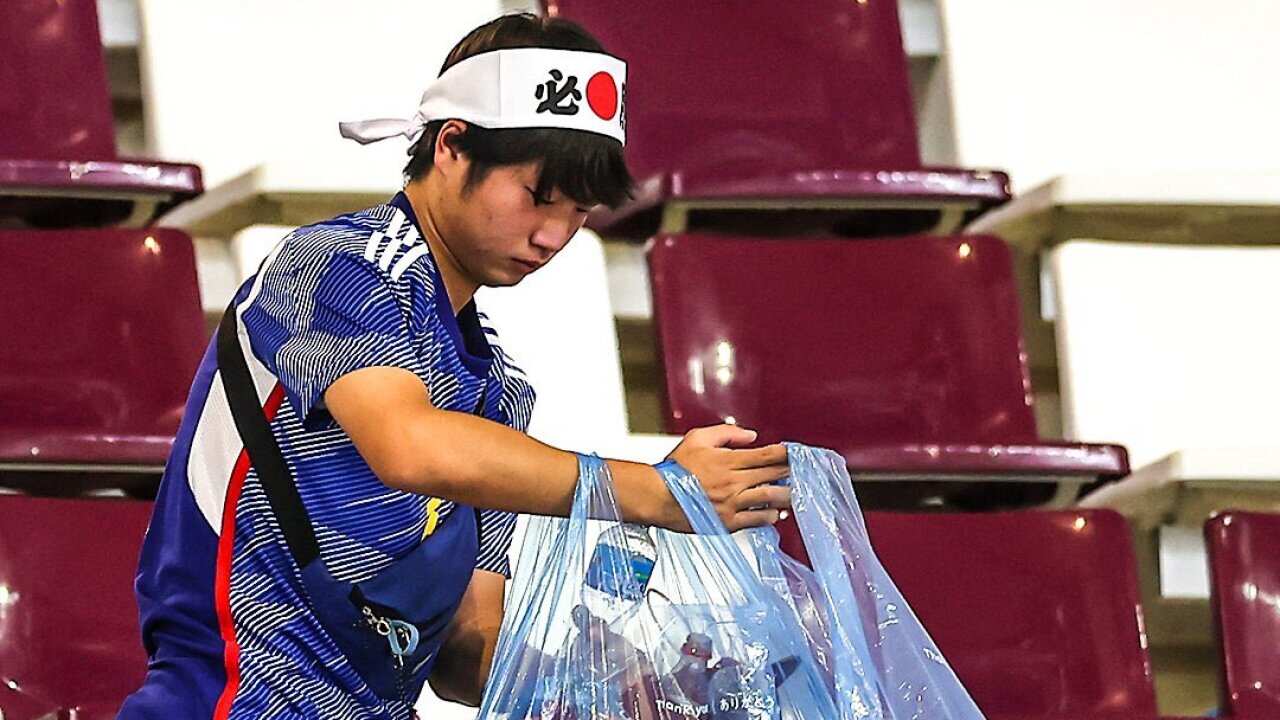 Man cleaning with a bag.