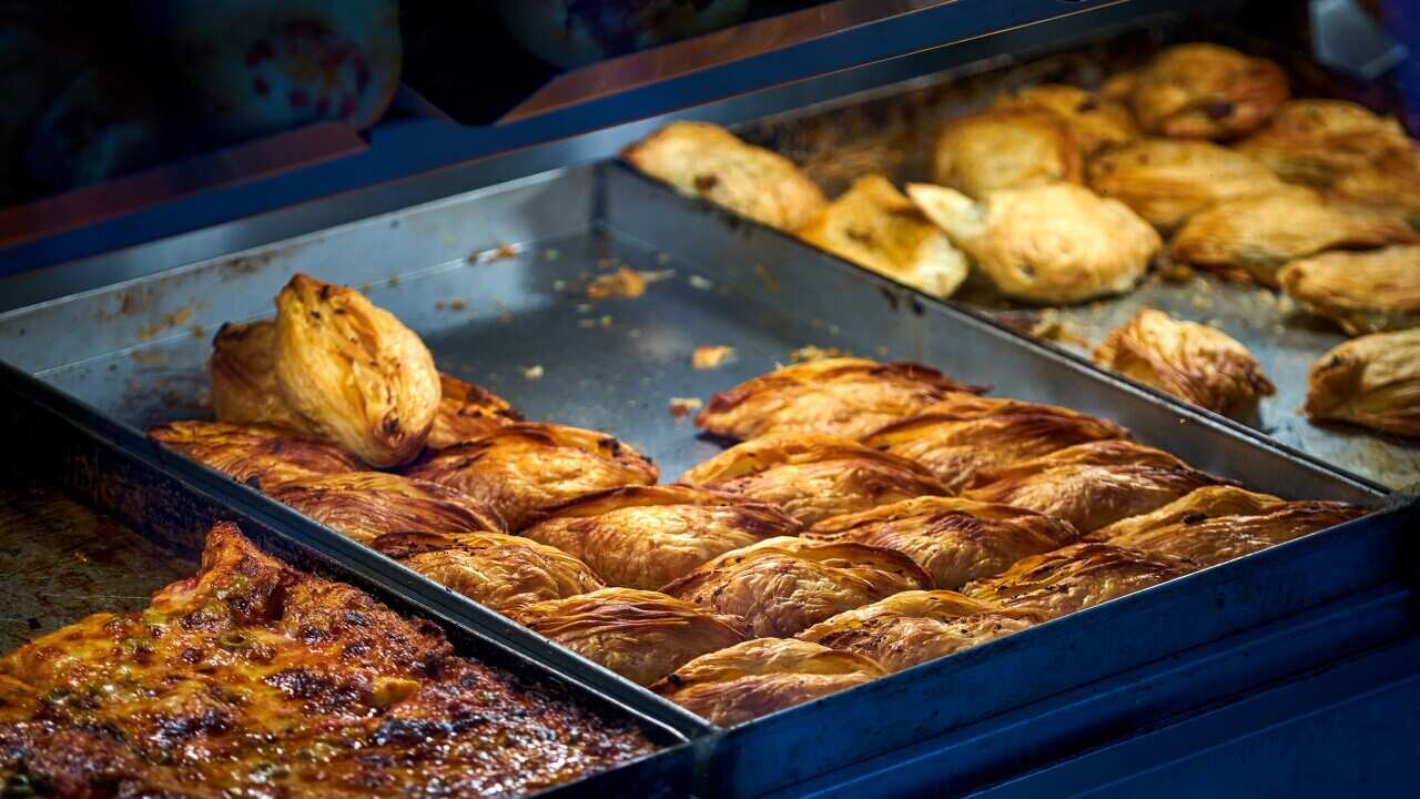 Maltese pastizzi on the counter of a pastizzeria.