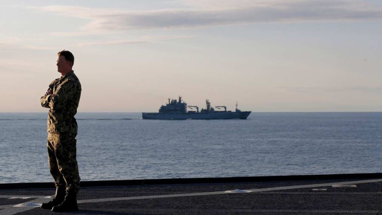  A US Navy soldier stands on the deck of the USS Mount Whitney ship