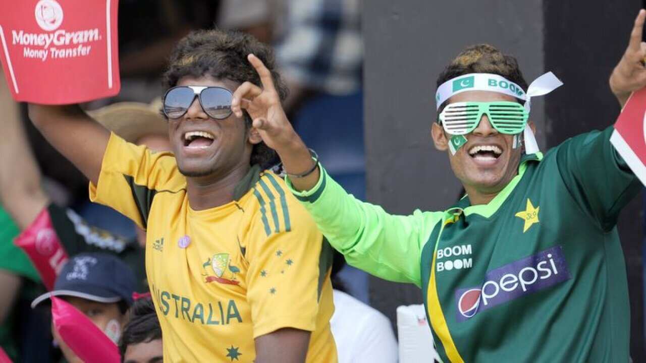 Australian and Pakistani fans dance befo