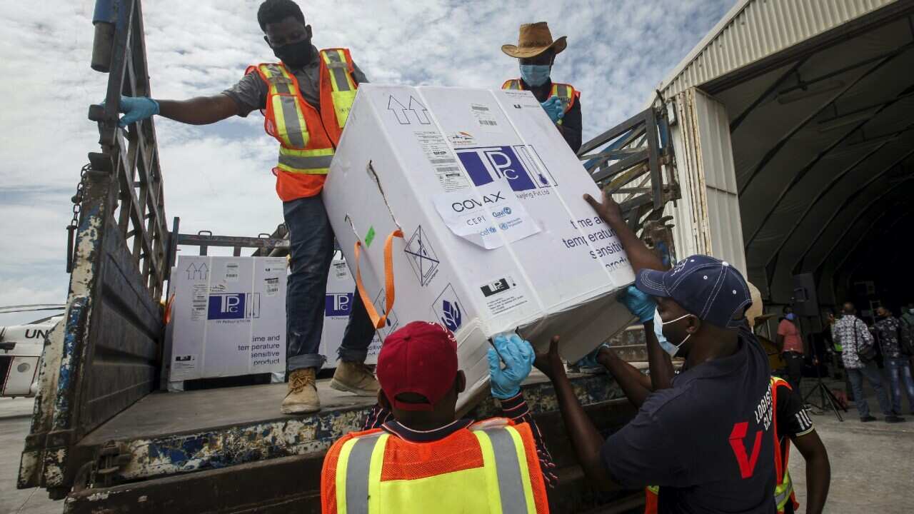 Boxes of AstraZeneca COVID-19 vaccine,  delivered through the COVAX global initiative, are unloaded in Mogadishu, Somalia.